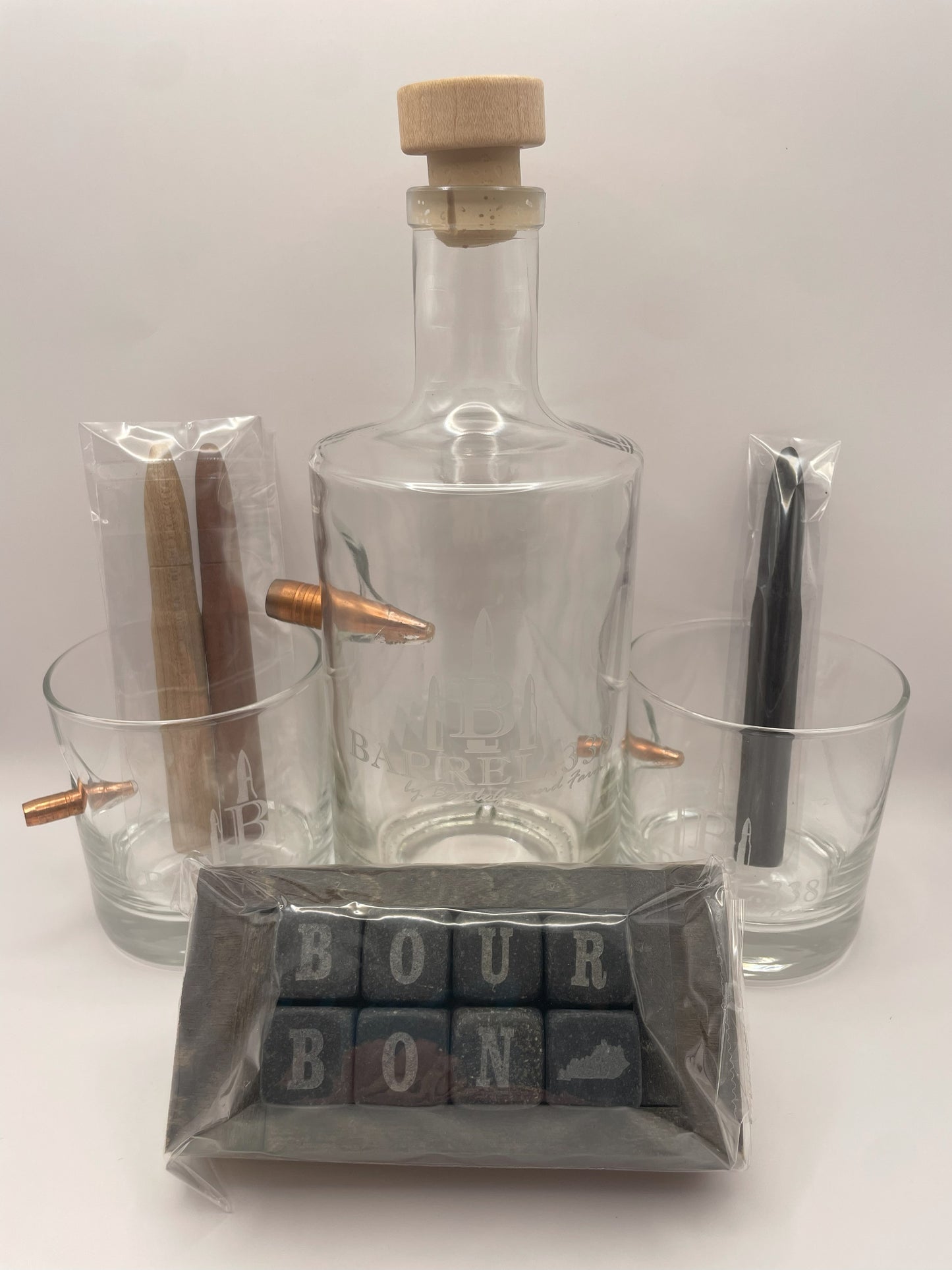 Image of a bourbon gift box containing two rocks glasses, cooling stones, a decanter, and bourbon smoothing and aging infusion staves.